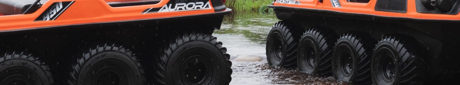 close-up of the tires of 2 orange Argo vehicles